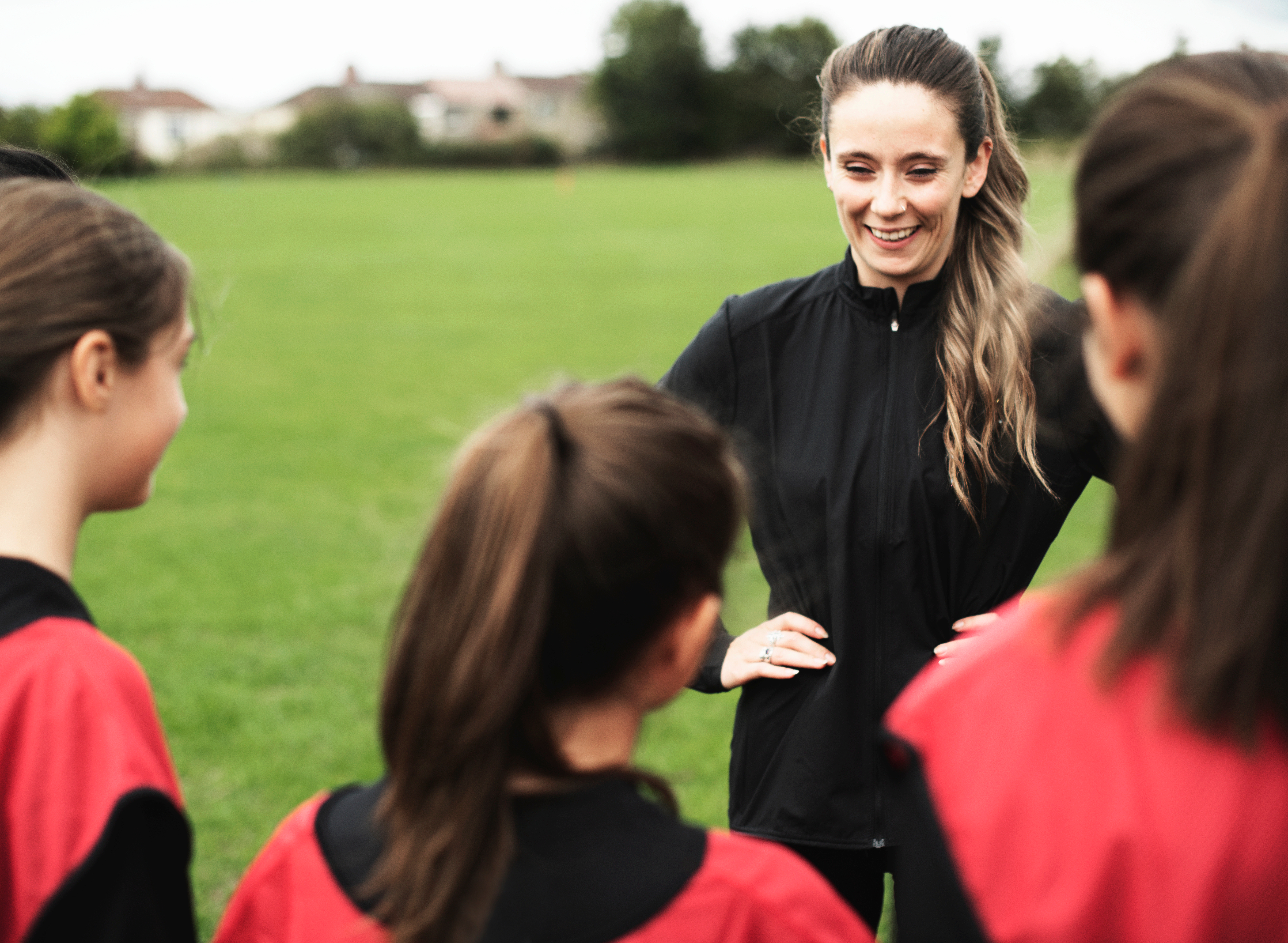 Coach smiling and talking to her players